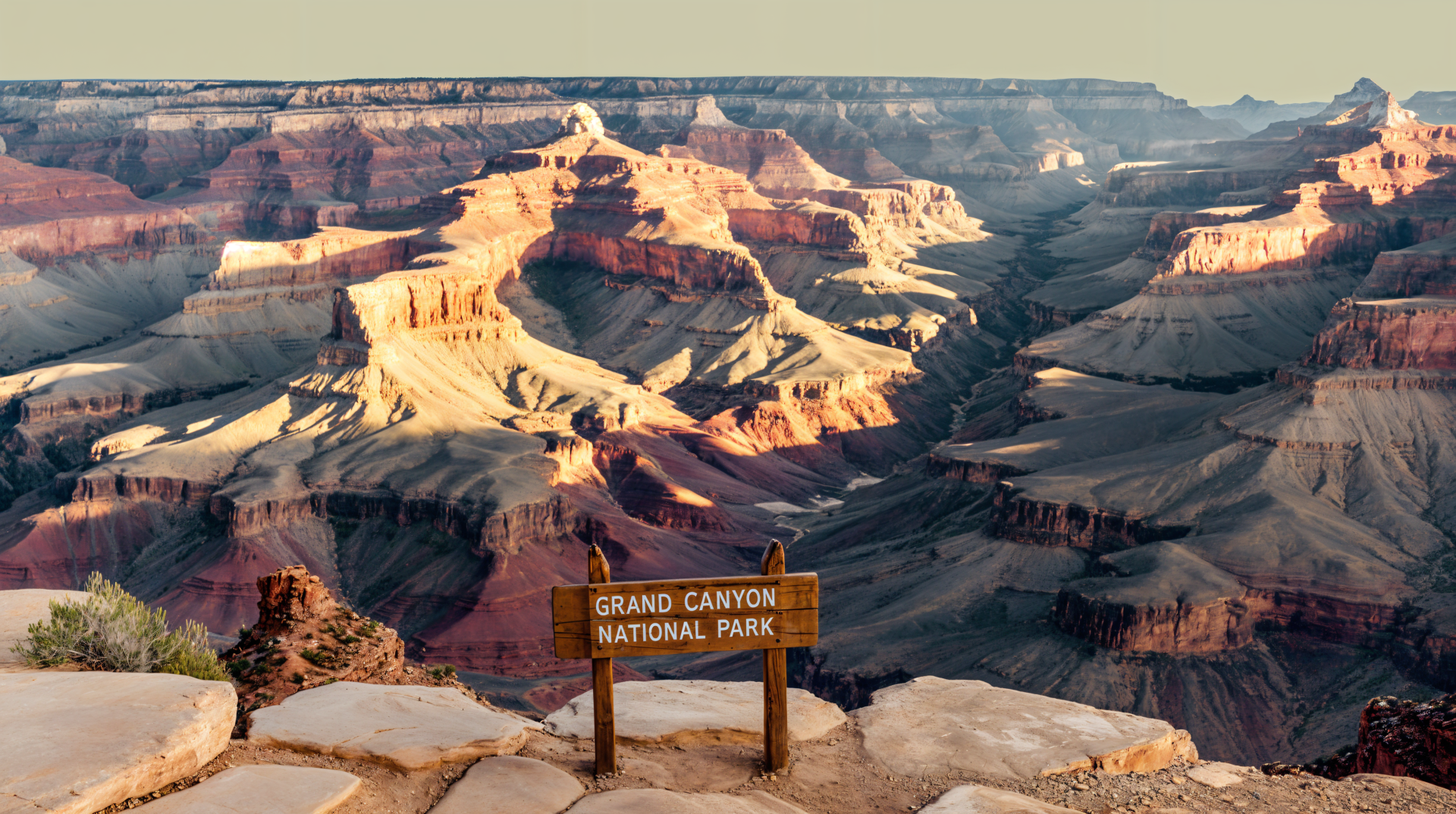 4K Ultra HD image of the Grand Canyon National Park showcasing its vast, layered rock formations under soft sunlight, captured as a PC desktop wallpaper and background.