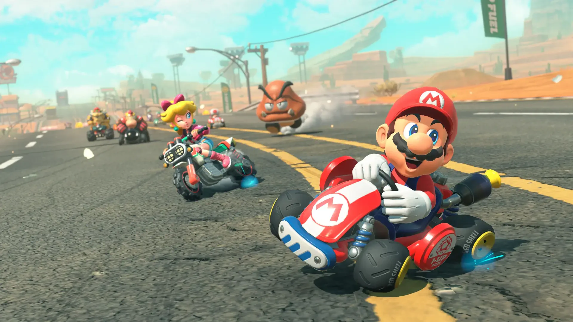 4K Ultra HD PC desktop wallpaper featuring vibrant action from the Mario Kart world, with Mario racing ahead on a dynamic, colorful track.