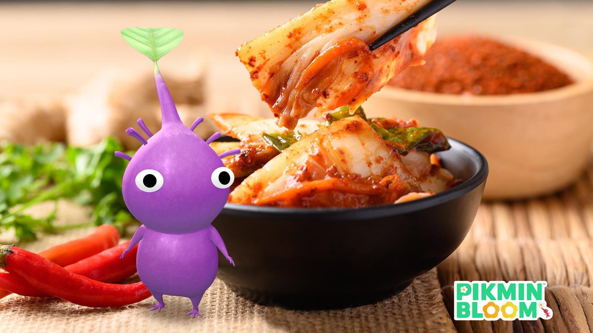 A vibrant HD PC desktop wallpaper featuring a purple Pikmin character beside a bowl of spicy, flavorful Korean kimchi with chopsticks lifting a piece.