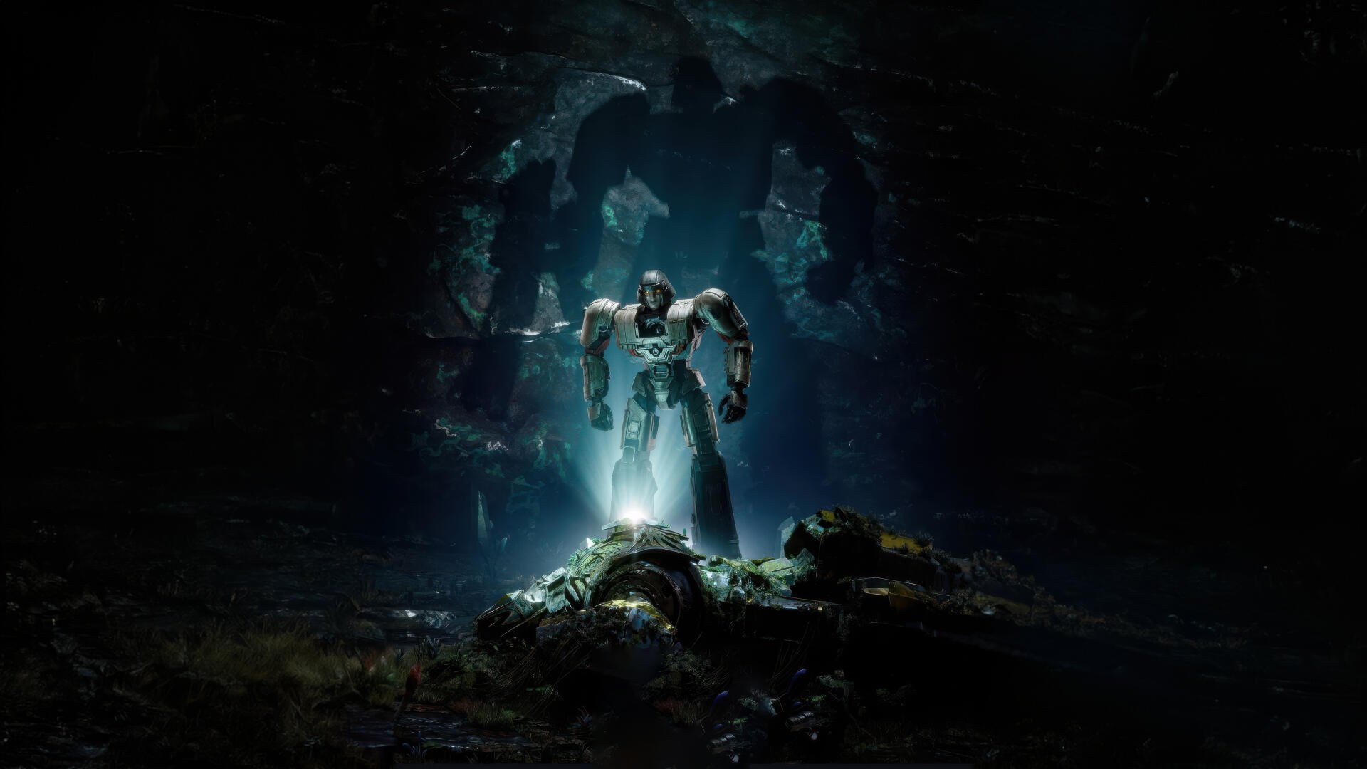 4K Ultra HD Transformers One wallpaper showing a glowing robot standing over a fallen figure in a dark, cave-like environment with a cracked wall behind.