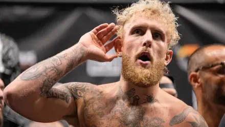 Jake Paul poses in the ring, showcasing his tattoos and intense expression, embodying the spirit of boxing in this HD desktop wallpaper.