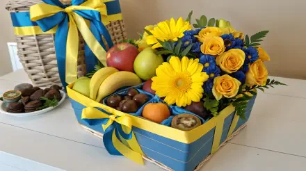 A beautifully arranged gift basket featuring colorful fruits, vibrant yellow flowers, and decorative ribbons, presented as a 4K Ultra HD desktop wallpaper.