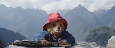 A charming HD desktop wallpaper featuring Paddington bear in Peru, set against a stunning mountainous backdrop, showcasing his adventurous spirit and beloved character.
