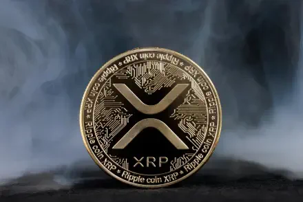 HD desktop wallpaper featuring a detailed XRP cryptocurrency coin with digital circuit patterns against a smoky, dark background highlighting technology and finance.