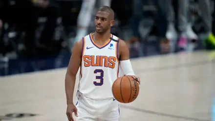 HD basketball wallpaper featuring NBA player Chris Paul in his Phoenix Suns uniform, dribbling on the court during a game.
