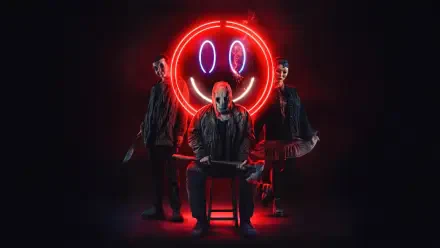 A 4K Ultra HD PC desktop wallpaper featuring three masked figures from The Strangers: Chapter 2 against a dark background with a glowing red neon smiley face.