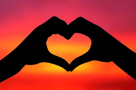 HD PC desktop wallpaper/background of silhouetted hands forming a heart against a vibrant sunset sky, conveying love.