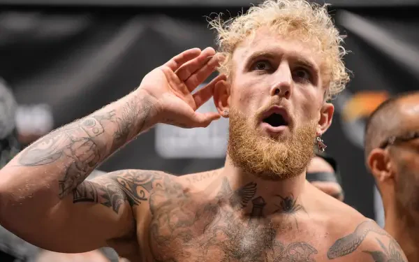 Jake Paul poses in the ring, showcasing his tattoos and intense expression, embodying the spirit of boxing in this HD desktop wallpaper.