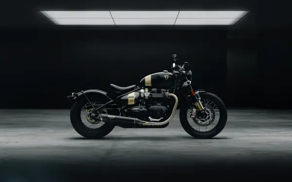 A sleek Triumph Bonneville Bobber TFC motorcycle displayed in a dimly lit garage, showcasing its modern design and craftsmanship in high-resolution 4K detail.