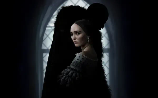Nosferatu (2024) 4K Ultra HD PC desktop wallpaper featuring a dark, shadowy figure looming behind a pale woman in front of a gothic arched window.