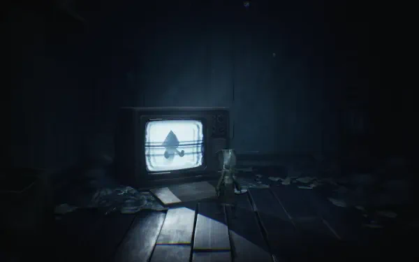 A dark, atmospheric HD wallpaper from Little Nightmares features Six standing in a dim room, with an old television casting eerie light amidst scattered debris.