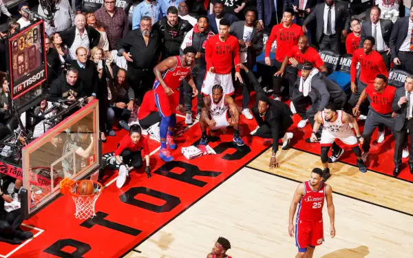 Exciting NBA action featuring the Toronto Raptors with Kawhi Leonard. Fans are engaged as a crucial play unfolds on the court, capturing the intensity of basketball at its best.