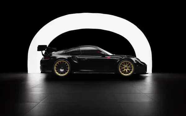 Sleek black Porsche 911 with gold wheels showcased in a dramatic minimalist setting, captured in 4K Ultra HD for a stunning PC desktop wallpaper.
