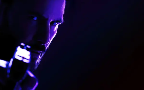 Close-up of Keanu Reeves as John Wick in a dark, moody 4K Ultra HD movie wallpaper for PC desktop background.