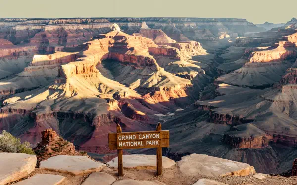 4K Ultra HD image of the Grand Canyon National Park showcasing its vast, layered rock formations under soft sunlight, captured as a PC desktop wallpaper and background.