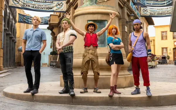 One Piece (Live Action) 4K Ultra HD wallpaper — Straw Hat crew posing in a sunlit town square, Luffy center with his straw hat raised.