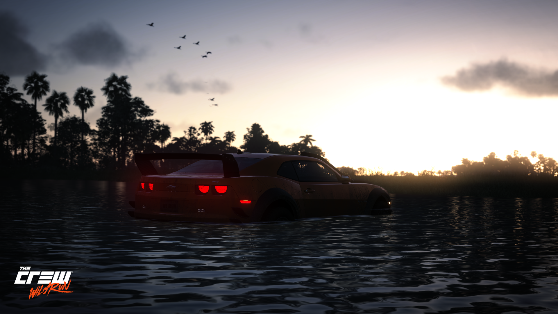Chevrolet Camaro sitting in a swampy circuit at sunset, silhouetted against a glowing sky — The Crew 2K Quad HD PC desktop wallpaper.