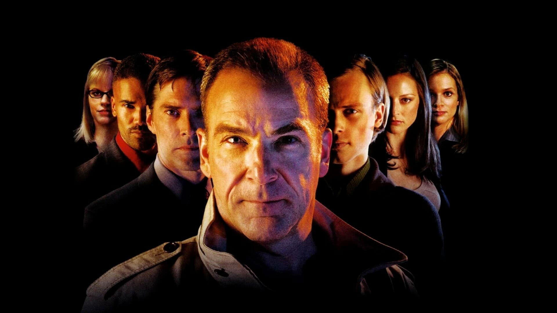 HD PC desktop wallpaper for Criminal Minds: dramatic close-up lineup of the show's characters in moody lighting against a black background.
