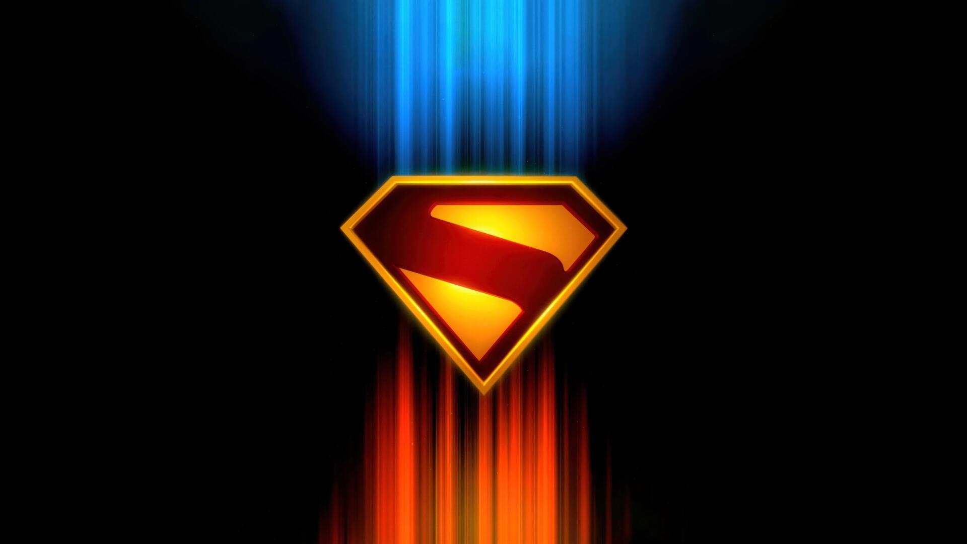 Superman (2025) shield glowing red and gold with blue and orange vertical light streaks; 4K Ultra HD PC desktop wallpaper/background.