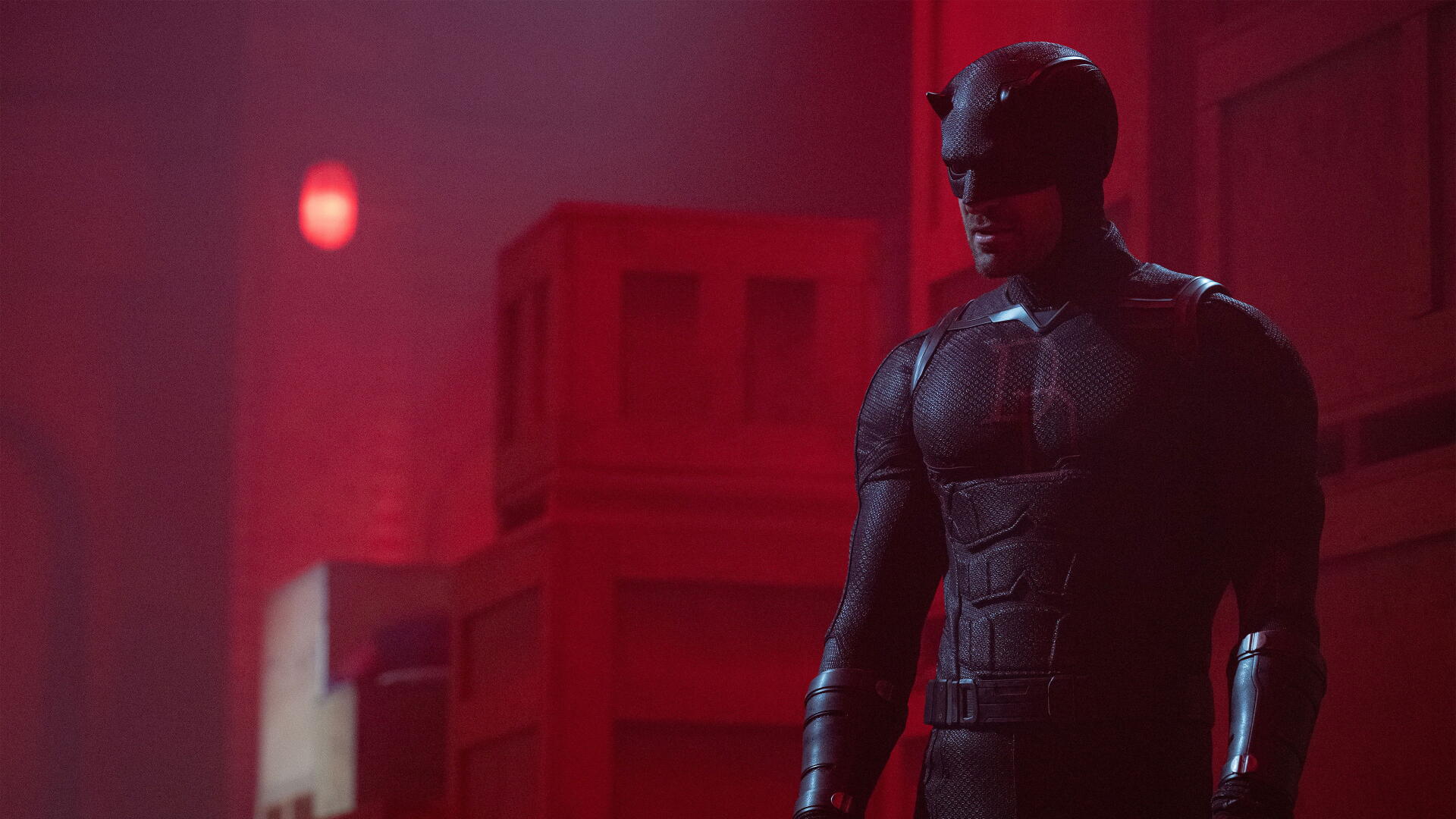 Daredevil: Born Again — armored Daredevil stands in a red-lit corridor, dramatic shadows and texture, high-detail 4K Ultra HD PC desktop wallpaper/background.