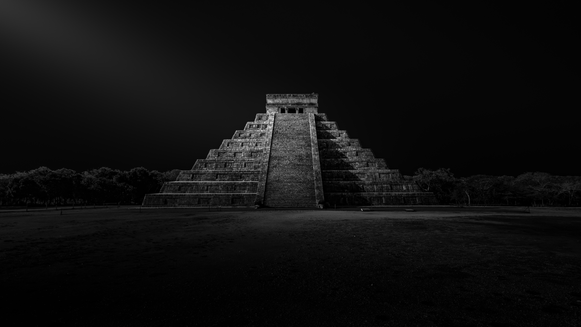 Monochrome 5K Ultra HD PC desktop wallpaper of Chichen Itza pyramid monument in Mexico, dramatic low-light composition with stark shadows.