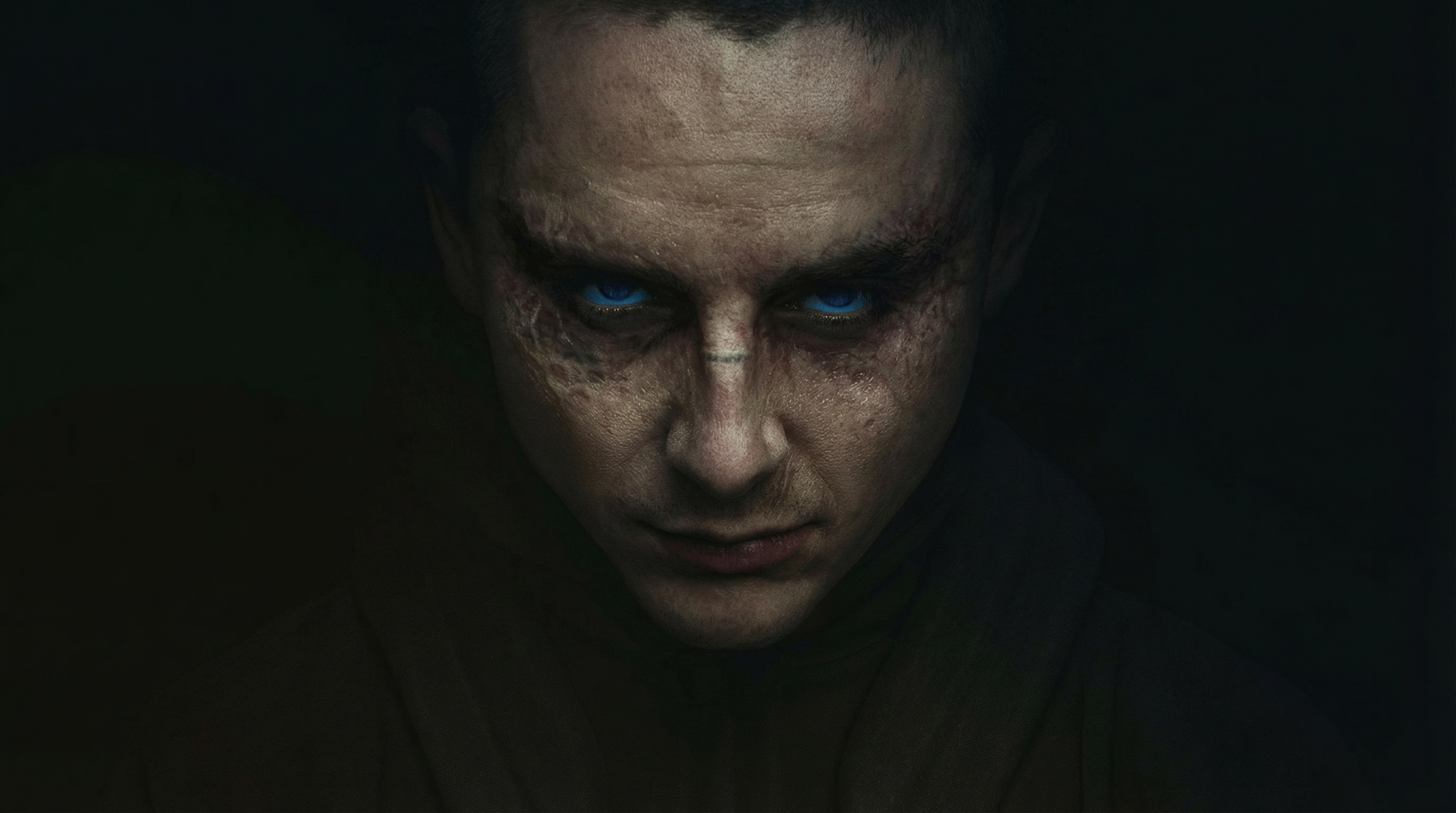 Moody close-up of a man's face with glowing blue eyes from Dune: Part Three; 2K Quad HD PC desktop wallpaper/background, shadowed sci‑fi portrait.