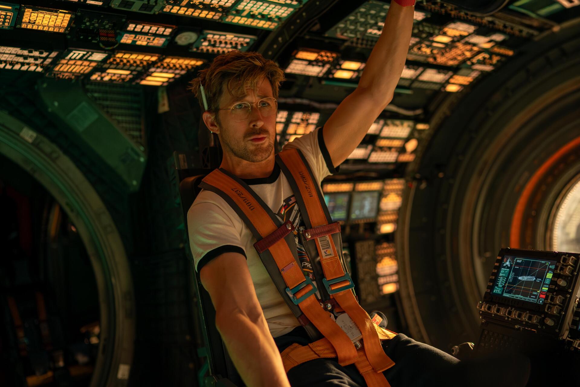 4K Ultra HD PC desktop wallpaper from the movie Project Hail Mary: astronaut in an orange harness reaches inside a glowing spacecraft cockpit.