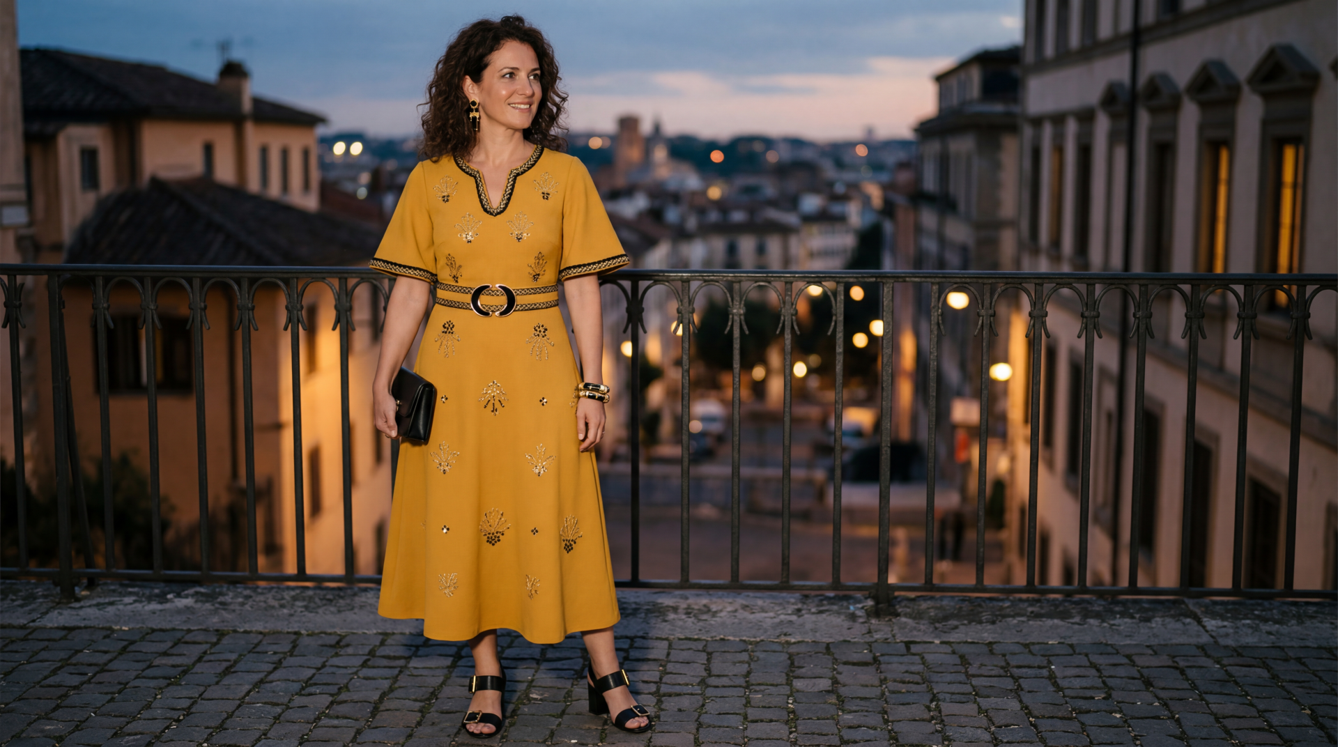 Woman in a flowing yellow dress on a cobblestone balcony overlooking a lit city at dusk — 5K Ultra HD PC desktop wallpaper and background.