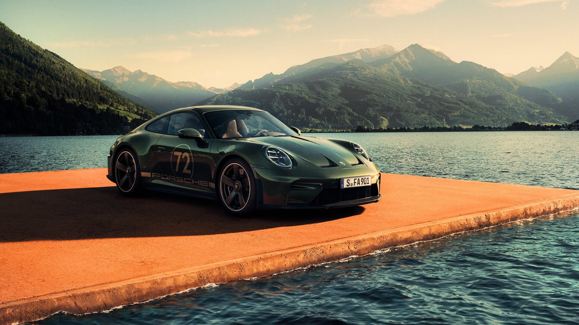 Porsche 911 GT3 parked on a pier beside a mountain lake at sunset — 4K Ultra HD PC desktop wallpaper of a green performance car/vehicle.