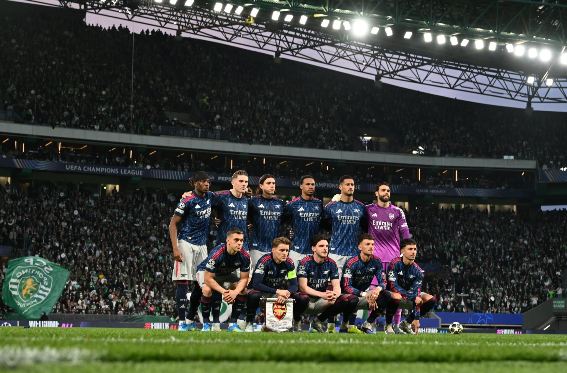 Arsenal F.C. squad lined up on the pitch before a UEFA Champions League match, 4K Ultra HD PC desktop wallpaper and background.