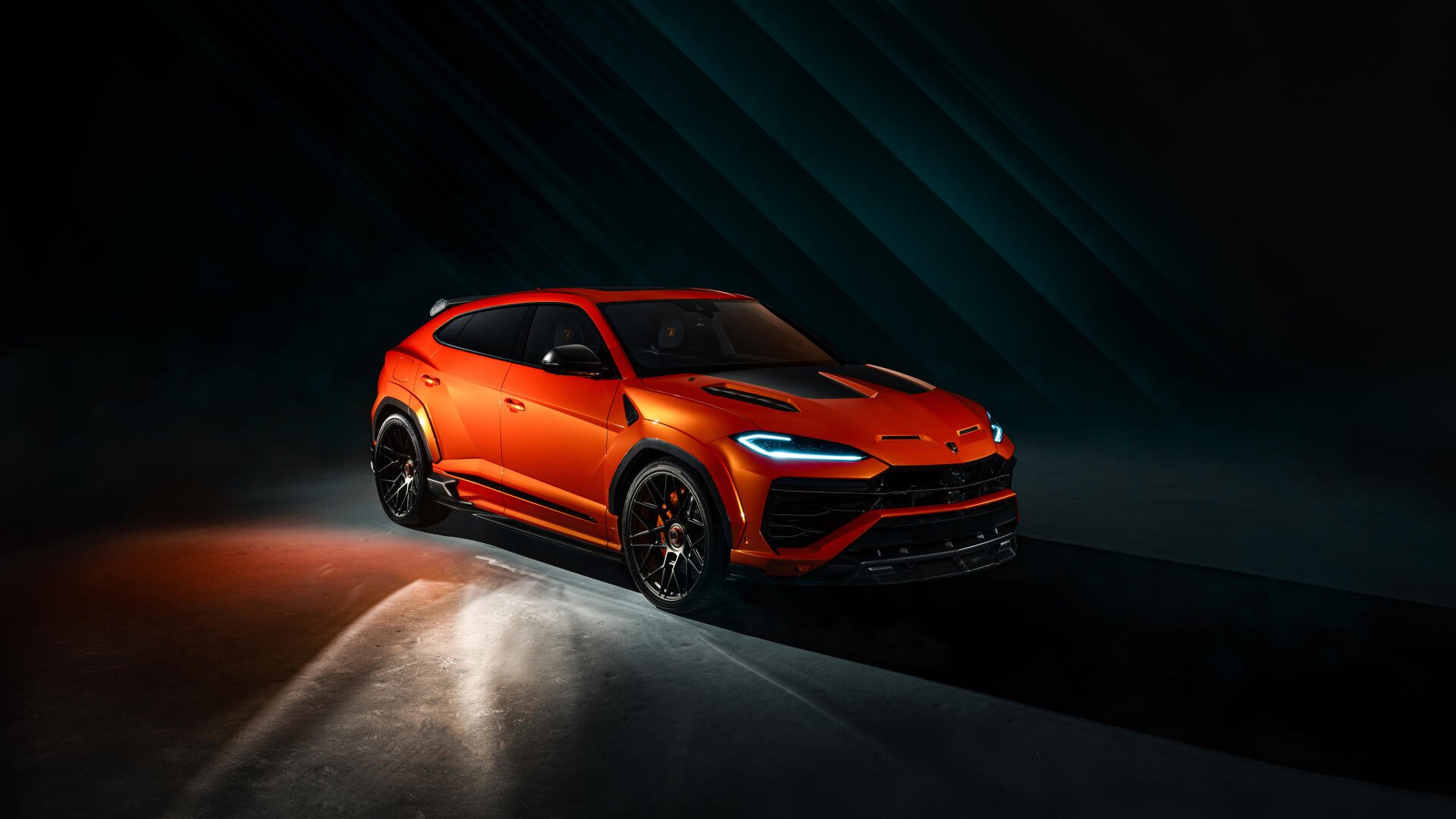 Orange Lamborghini Urus SUV in dramatic lighting, high-detail 8K Ultra HD PC desktop wallpaper background.