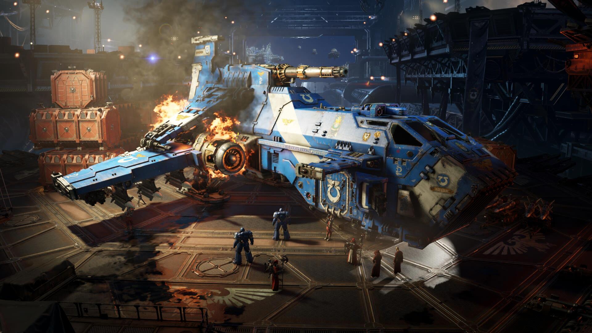 Video game Warhammer Space Marine 4K Ultra HD PC desktop wallpaper/background: blue Space Marine gunship in a smoky hangar, scorched hull and crew amid burning engines.
