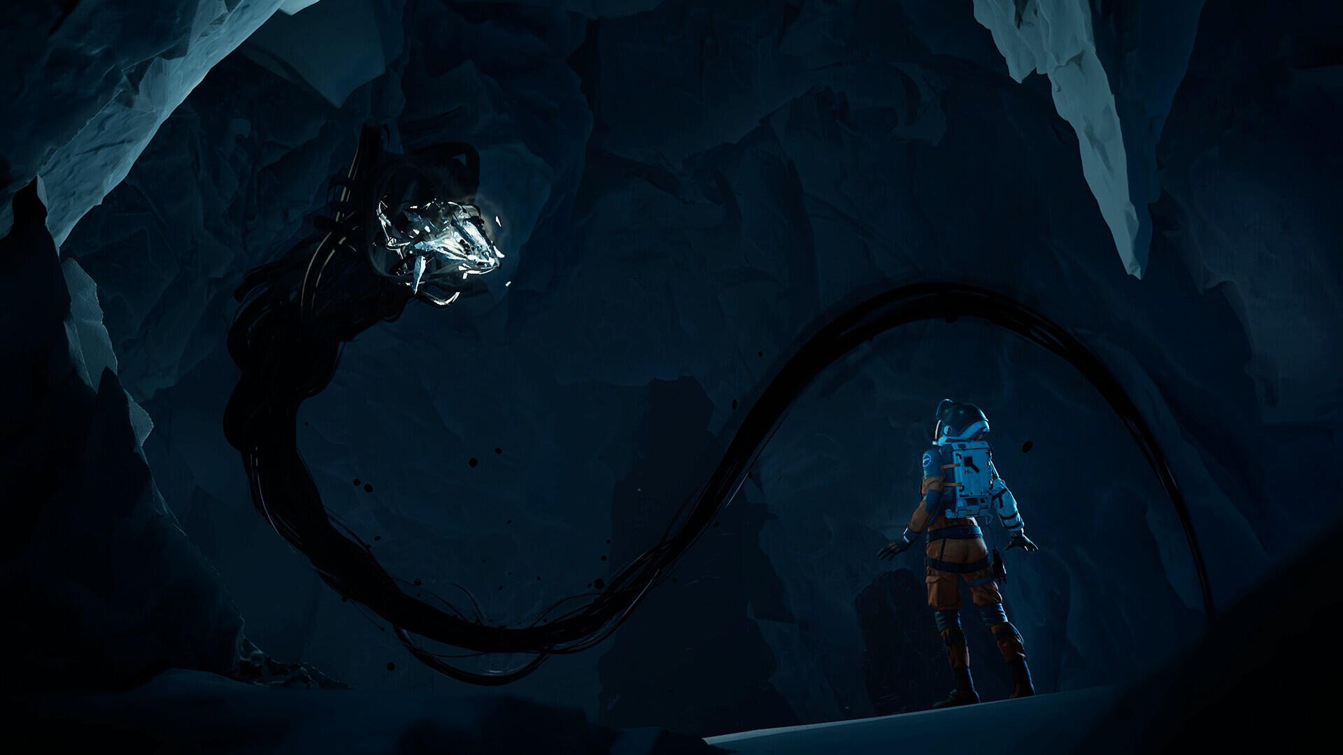 HD PC desktop wallpaper from video game Aphelion: lone armored figure in a blue cloak stands on an icy cavern ledge facing a towering shadowy tentacled creature with a glowing crystalline head.