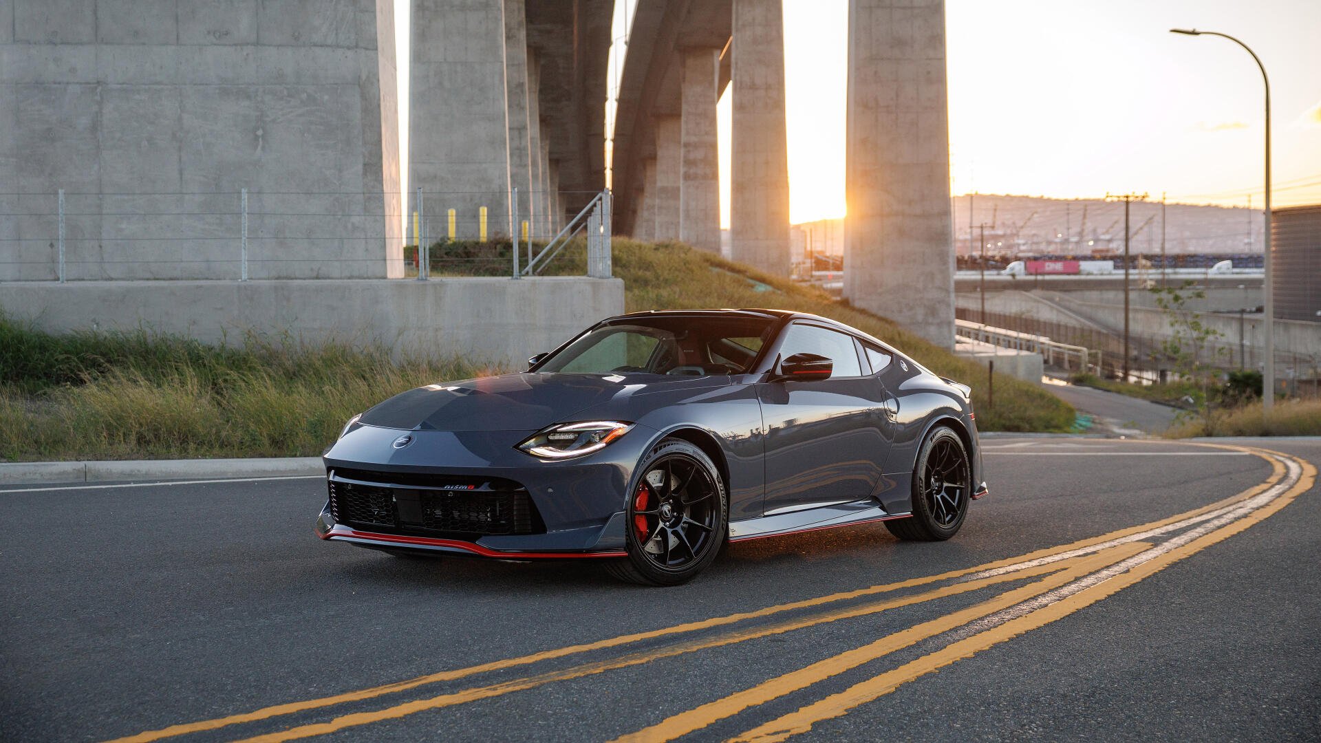 Nissan Z Nismo sports vehicle parked on an urban road beneath a concrete bridge at sunset — 4K Ultra HD PC desktop wallpaper and background.