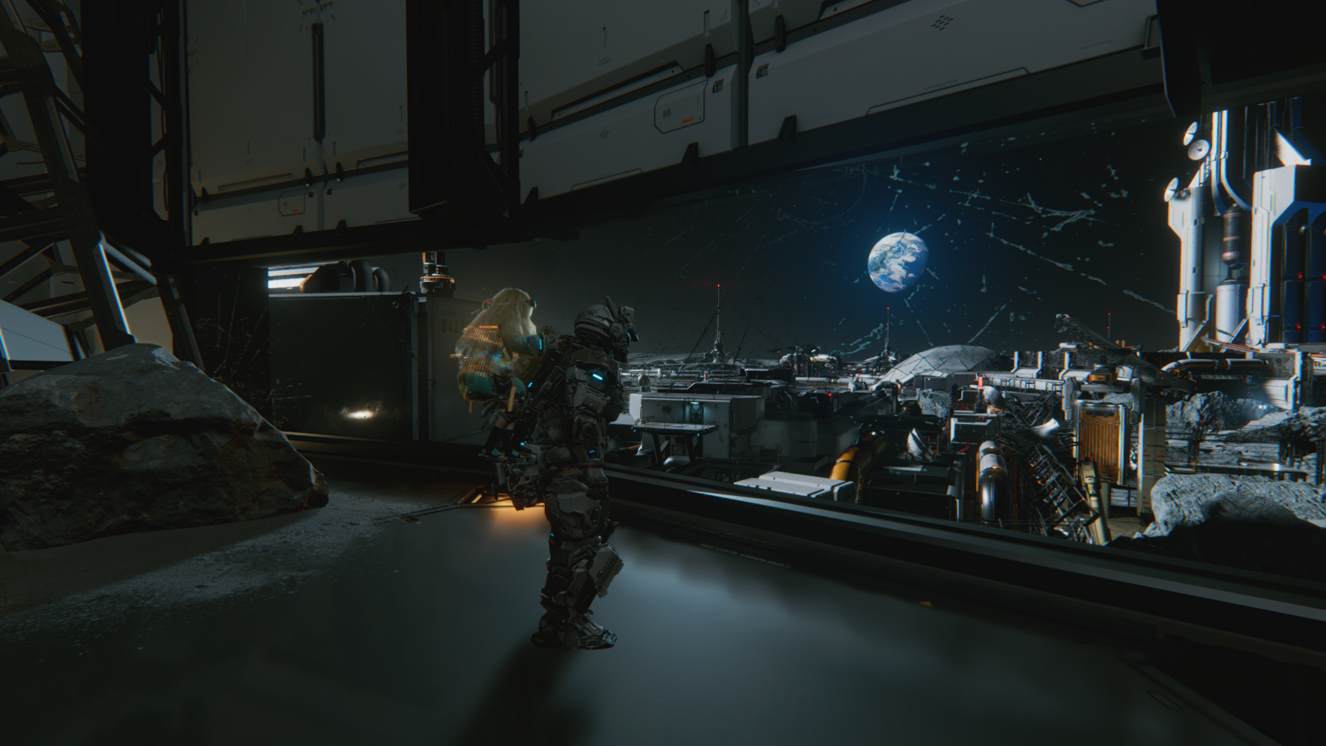 HD PC desktop wallpaper and background from the video game Pragmata: a lone astronaut in a dim lunar hangar gazes at a moonlit base with Earth rising above the horizon.