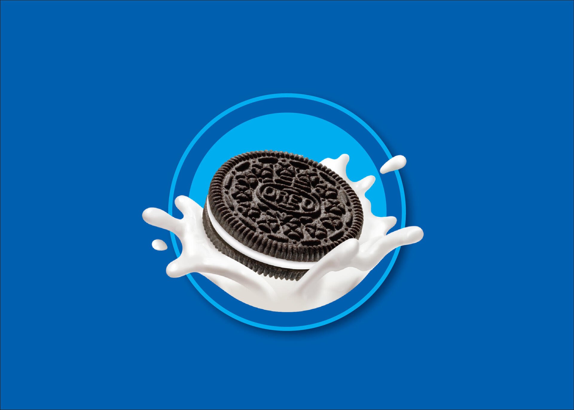 HD PC desktop wallpaper showing an Oreo cookie splashing into milk on a vivid blue background, a food-themed cookie image.