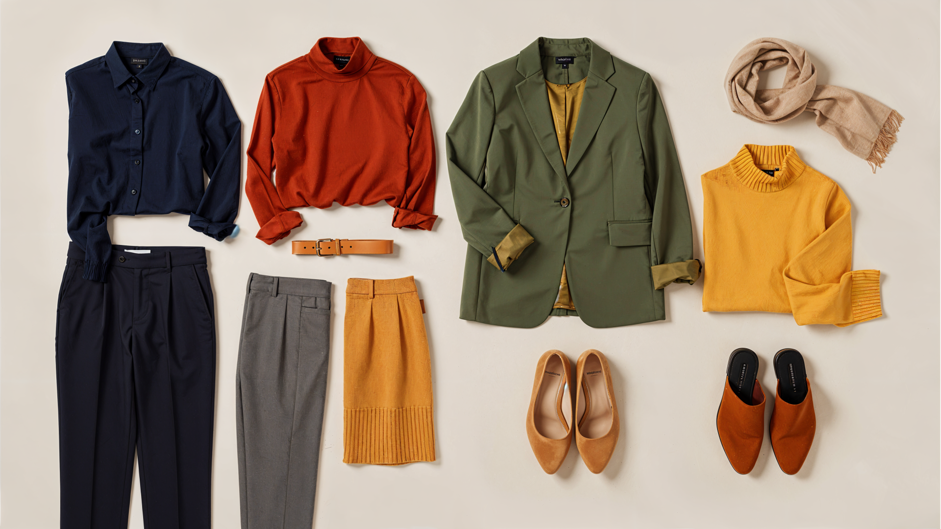 Capsule wardrobe flatlay of navy, rust, olive and mustard pieces with shoes and scarf — 4K Ultra HD PC desktop wallpaper background.