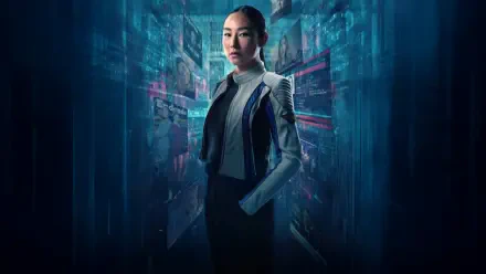 Tron: Ares 4K Ultra HD PC wallpaper — a poised woman in a futuristic jacket stands in a neon-blue digital corridor lined with holographic code and glowing circuitry.