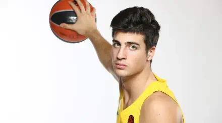 HD PC desktop wallpaper of a basketball player in a yellow jersey holding a ball overhead against a white background, close-up portrait with a focused expression.