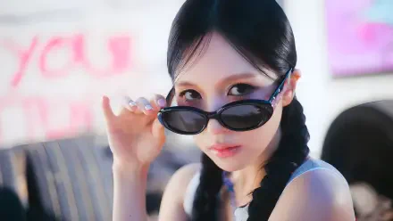 4K desktop wallpaper of a K-pop idol in shades with braided pigtails, evoking Twice's chic aesthetic.