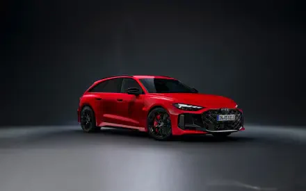 Red Audi RS5 sports car on a dark studio floor, presented as a 2K Quad HD PC desktop wallpaper/background.