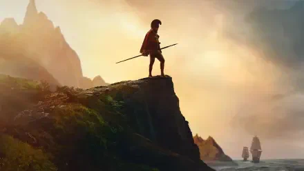Chief of War silhouetted on a cliff at dawn, spear in hand watching ships below — 4K Ultra HD PC desktop wallpaper and background.