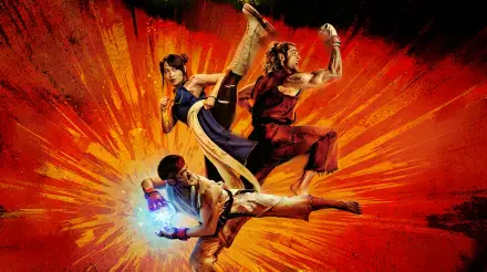 Street Fighter (2026) 2K Quad HD PC wallpaper and background: three fighters mid-air — high kick, spinning kick, energy-charged punch — over an explosive orange burst.
