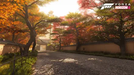 Forza Horizon 6 video game 4K Ultra HD PC desktop wallpaper: sunlit autumn avenue flanked by colorful maple trees, stone wall and a traditional gateway bathed in golden light.