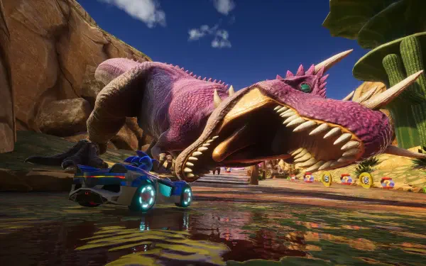 HD PC desktop wallpaper from the video game Sonic Racing: CrossWorlds — a blue racing car skids past a giant pink dinosaur snapping its jaws on a sunlit desert track.