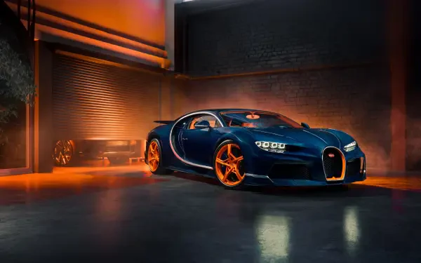 Blue Bugatti Chiron sports car with orange accents and gold wheels parked in a dramatic lit garage — 5K Ultra HD PC desktop wallpaper and background.