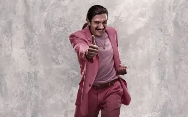 Street Fighter (2026) 2K Quad HD desktop wallpaper: man in a pink suit gives a thumbs-up while holding a hat, posed against a textured gray backdrop.