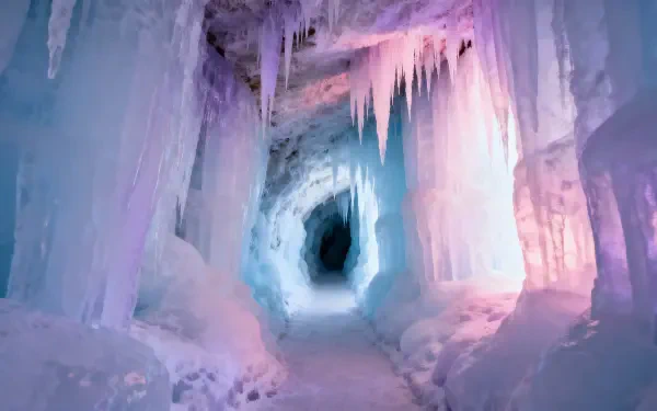 Ice cave interior with glowing blue and pink ice formations and hanging icicles, 4K Ultra HD PC desktop wallpaper and background.