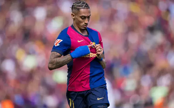 FC Barcelona soccer player adjusting his shirt on the pitch, captured in vibrant detail as a dynamic 5K Ultra HD PC desktop wallpaper background.