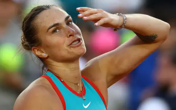 4K Ultra HD PC desktop wallpaper of a Belarusian female tennis player mid-match, wiping her brow in a turquoise top with a focused, determined expression